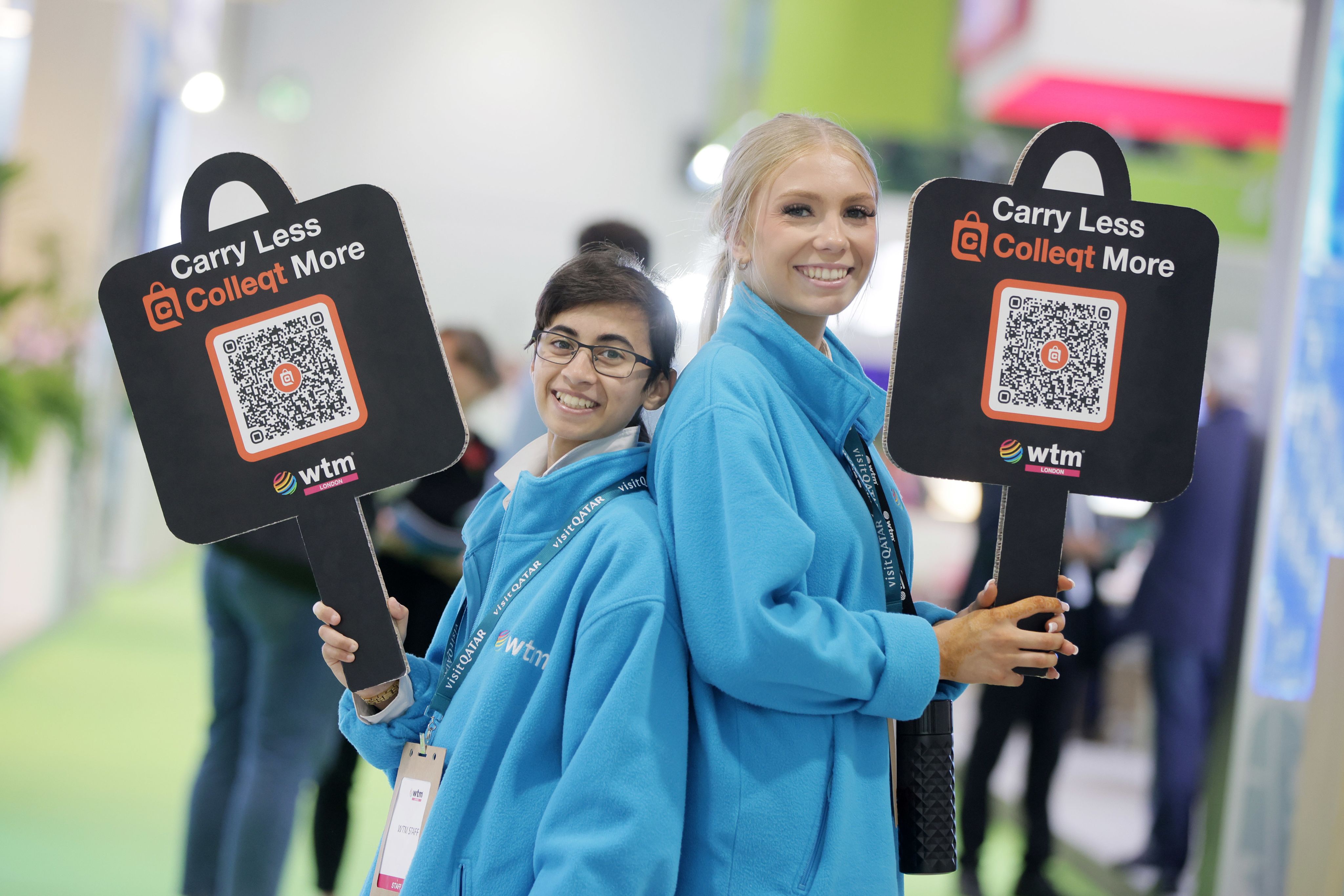 Two people holding advertising boards for Colleqt QR